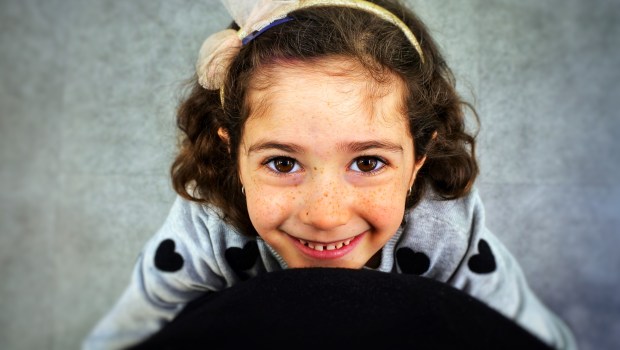 Girl looking up at parent