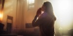 Christian Woman Getting on her Knees in Front of Altar and Starting to Pray in Church