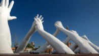 Big white hands sculpture Building Bridges by Lorenzo Quinn in the Biennale Art Exhibition Arsenale in Venice, Italy, 25th September, 2020