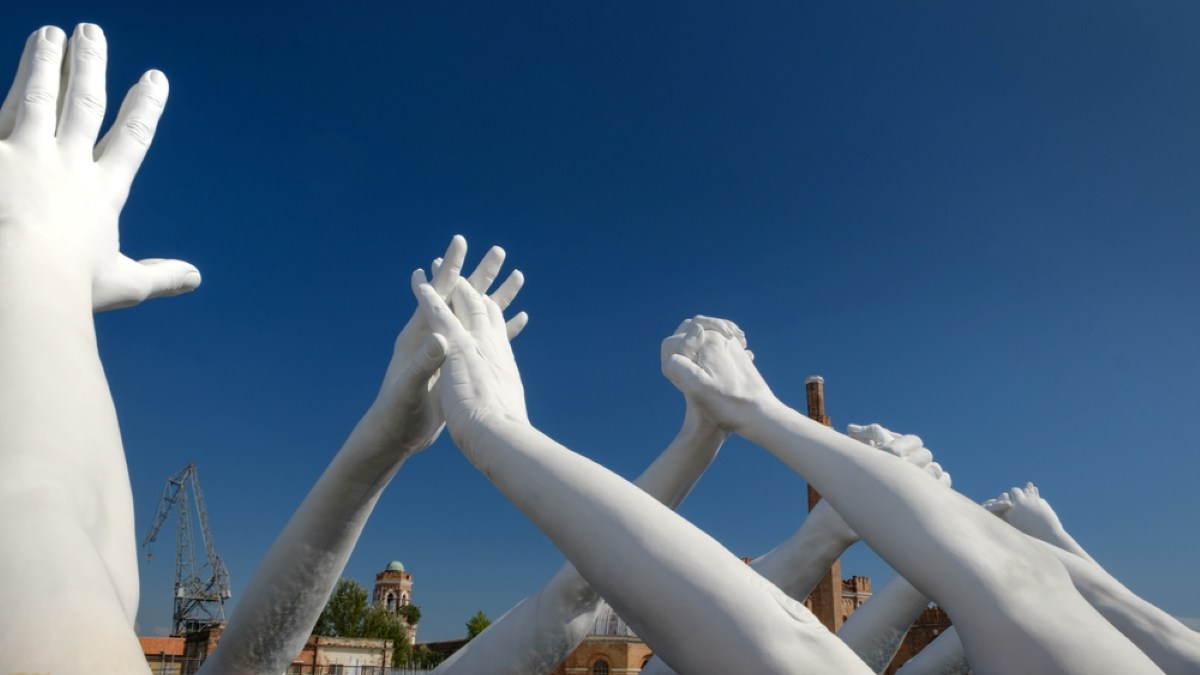 Big white hands sculpture Building Bridges by Lorenzo Quinn in the Biennale Art Exhibition Arsenale in Venice, Italy, 25th September, 2020