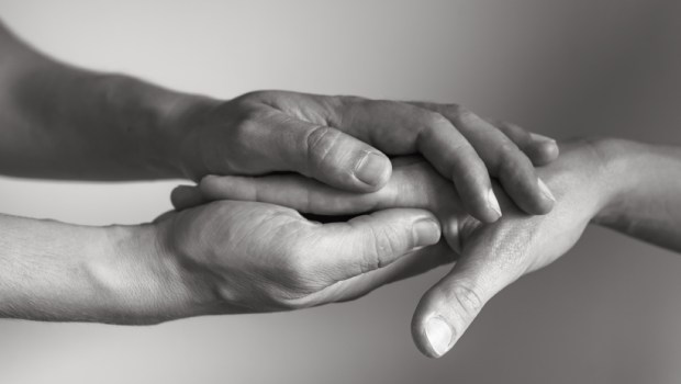 Hand holding another hand