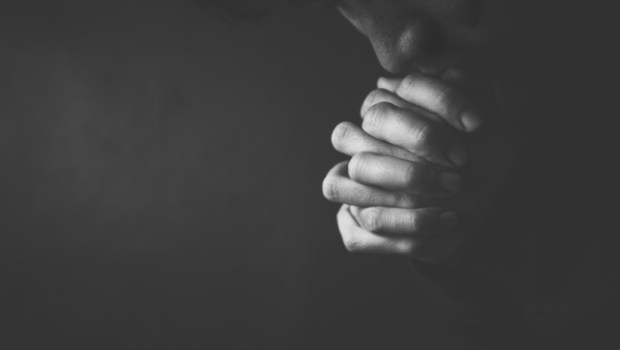 Praying man hoping for better