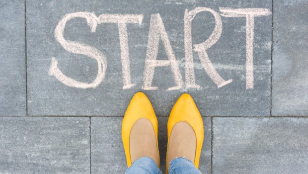Word start on the asphalt and feet woman