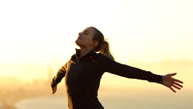Happy runner breathing fresh air