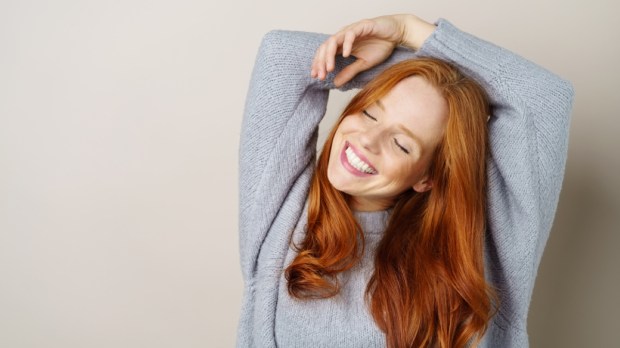 Happy carefree young redhead woman