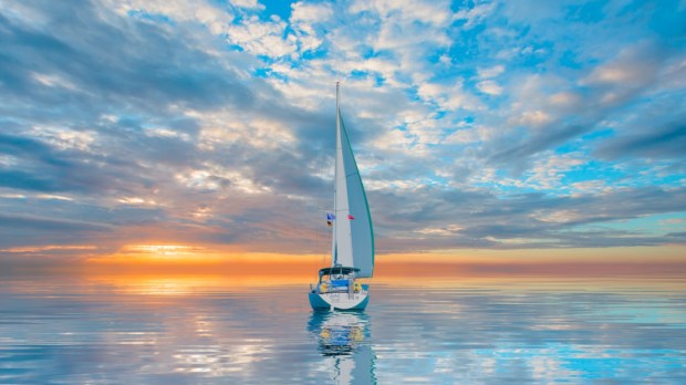 Lonely yacht sailing in the Mediterranean sea at amazing sunset