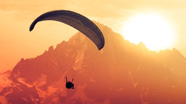 Sepia paraglide silhouette over Alps