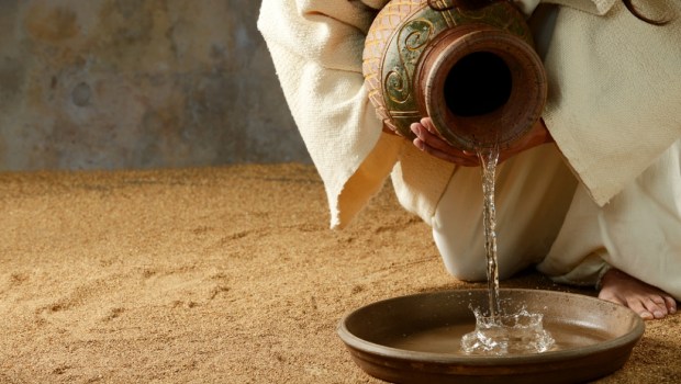 Jesus pouring water from a jar before the feet washing
