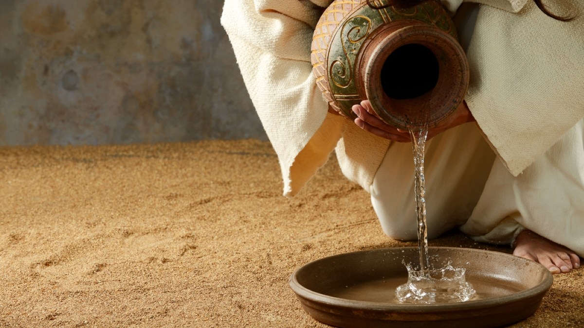 Jesus pouring water from a jar before the feet washing