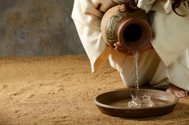 Jesus pouring water from a jar before the feet washing