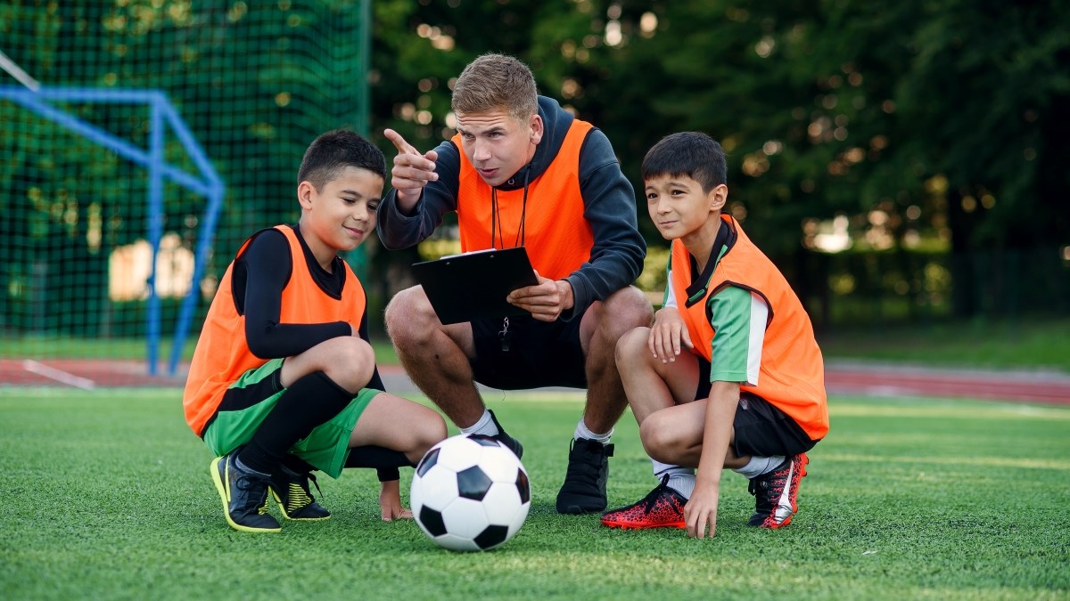 Football coach instruct teen football players
