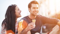 romantic couple eating ice cream at park