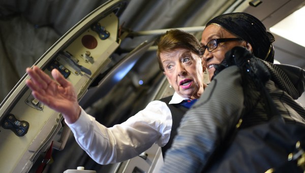 Flight attendant Bette Nash helps flier