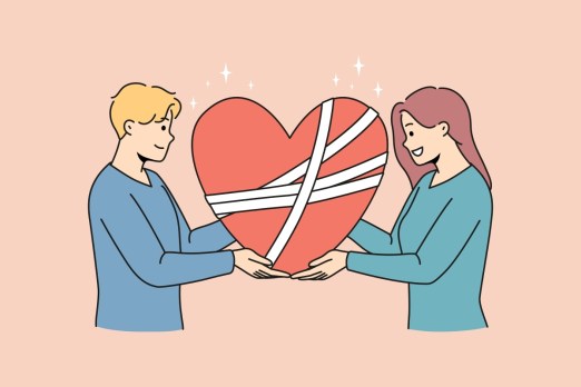 Happy man and woman hold in hands fixed broken heart with bandages on surface