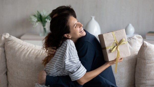 Happy young 30s latina woman embracing loving husband