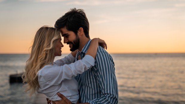 Lovely couple bonding at the beach in summer