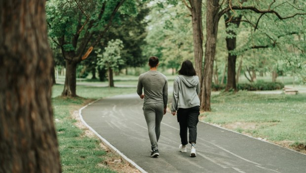 Sport couple walking on the path in the park