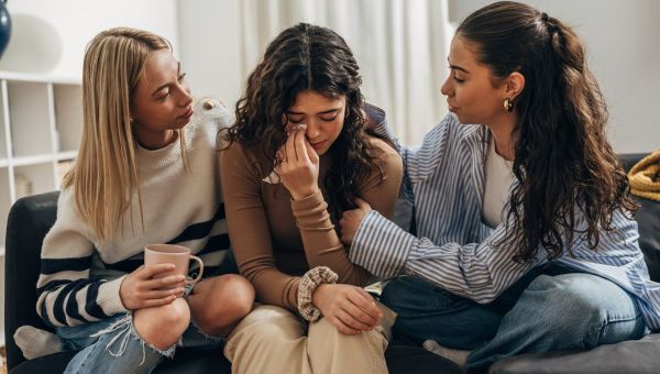 Women comforting their sad friend