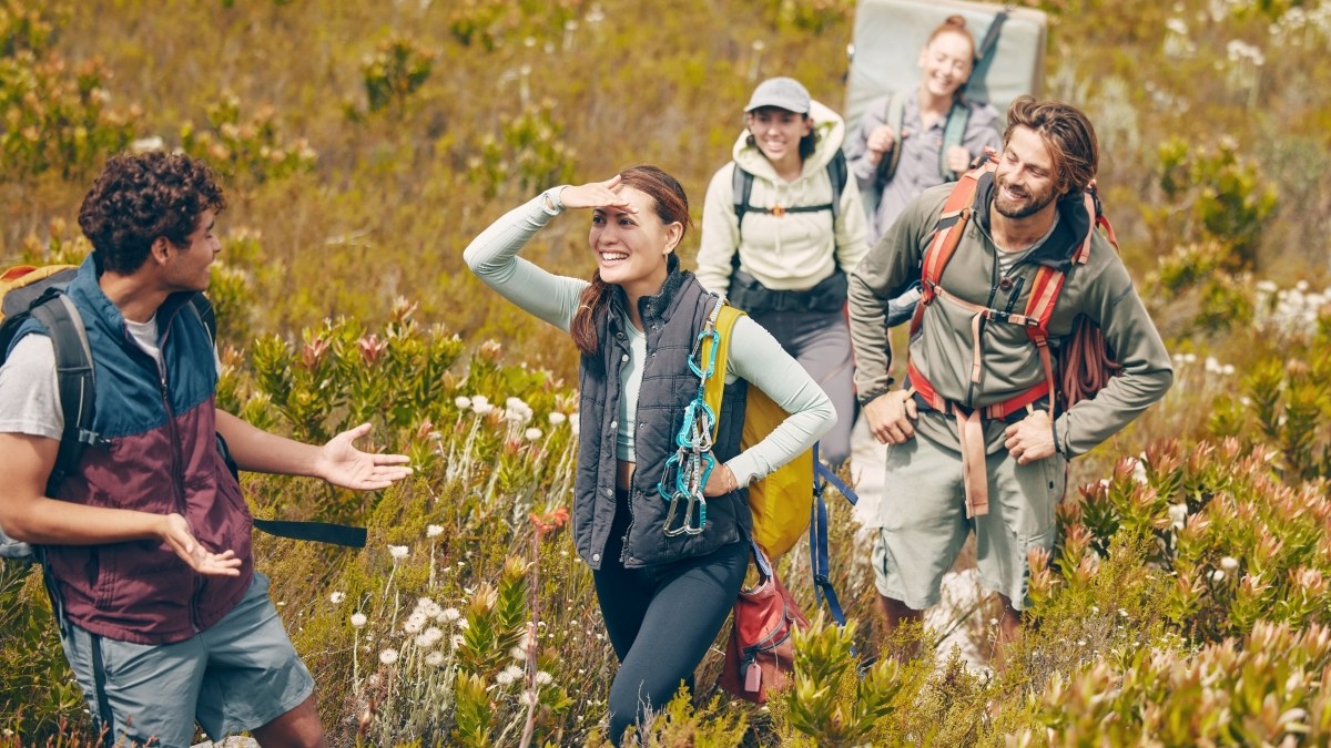 Group hiking, nature travel and guide in communication with friends