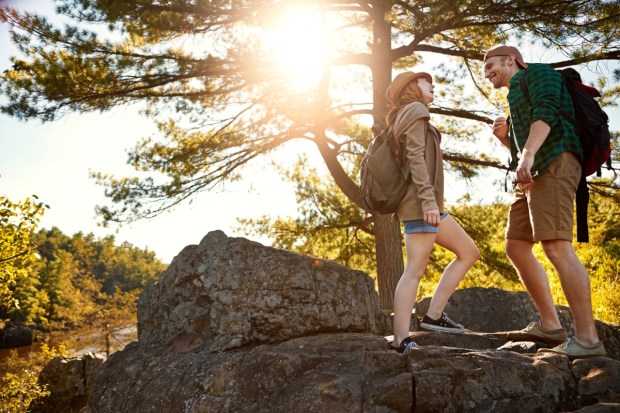 Nature, hiking and happy couple walking with conversation