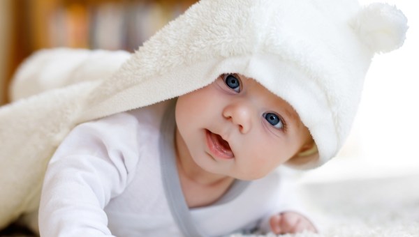 Baby girl with blue eyes wearing white towel