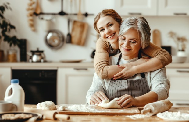 happy family grandmother old mother mother-in-law and daughter-in-law daughter cook in kitchen