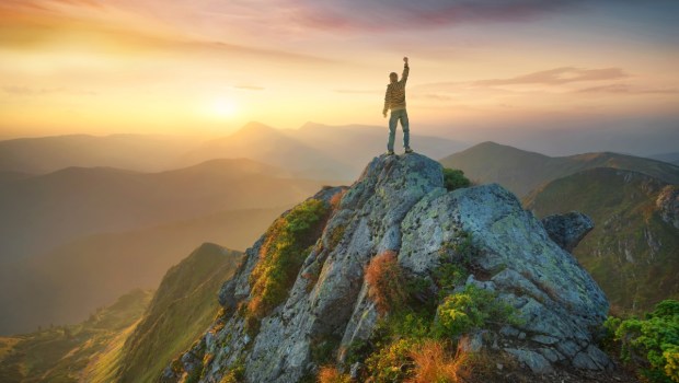 Tourist on the peak of high rocks