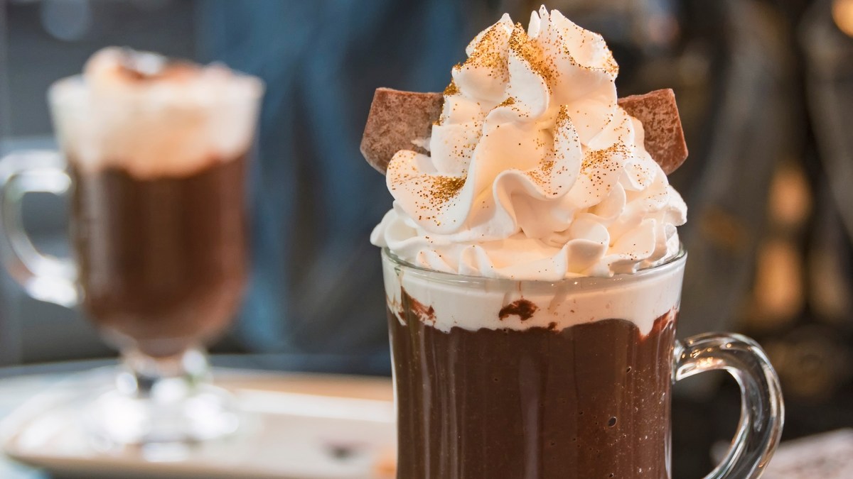 Hot chocolate with whipped cream and golden edible glitter