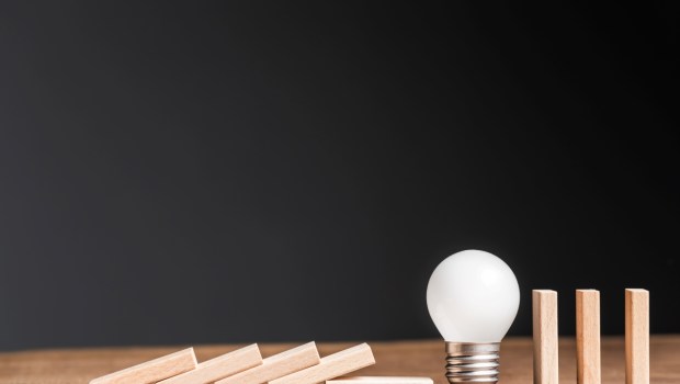 Small light bulb in a row of wooden domino