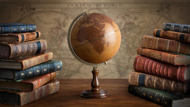 Old geographical globe and map and old book in cabinet