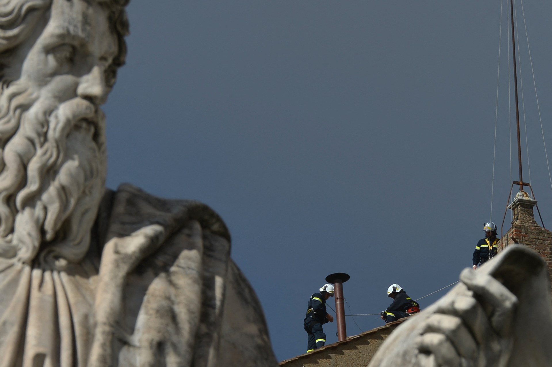 Vatican's firefighters setup the chimney on the roof of the Sistine chapel ahead of the cardinals conclave on March 9, 2013.