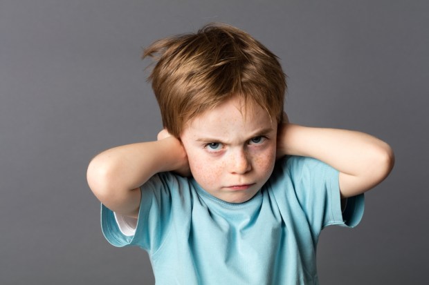 stubborn little kid with red hair, freckles and an attitude ignoring parents scolding