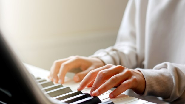 Boy's Hands practicing learning on Playing Piano