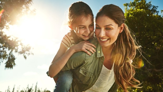 Mother, child and outdoor for piggy back with smile, bonding on vacation in Australia