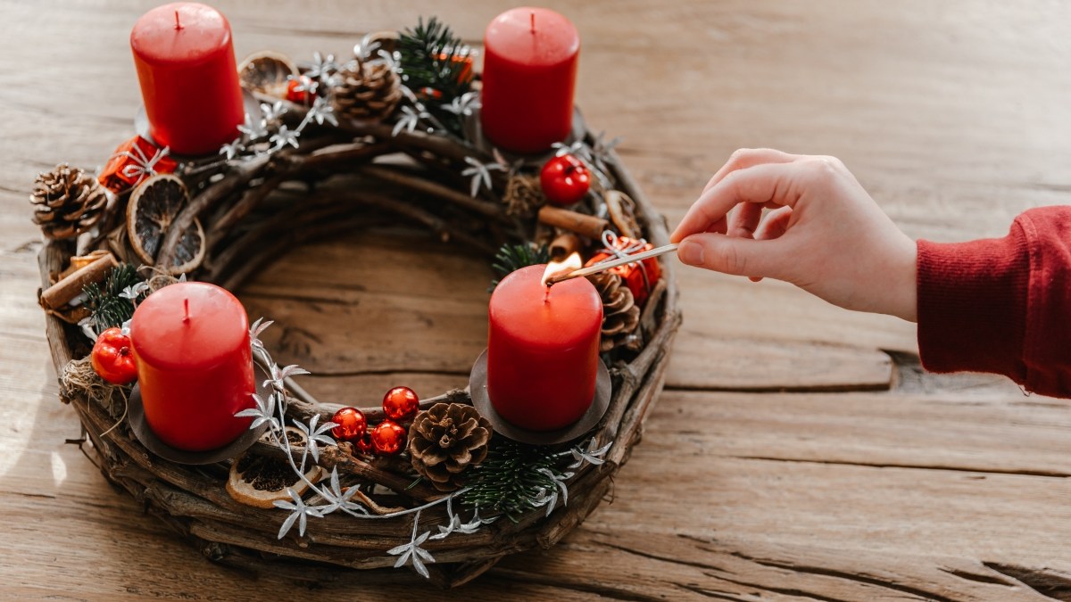First candle on advent wreath made with branches