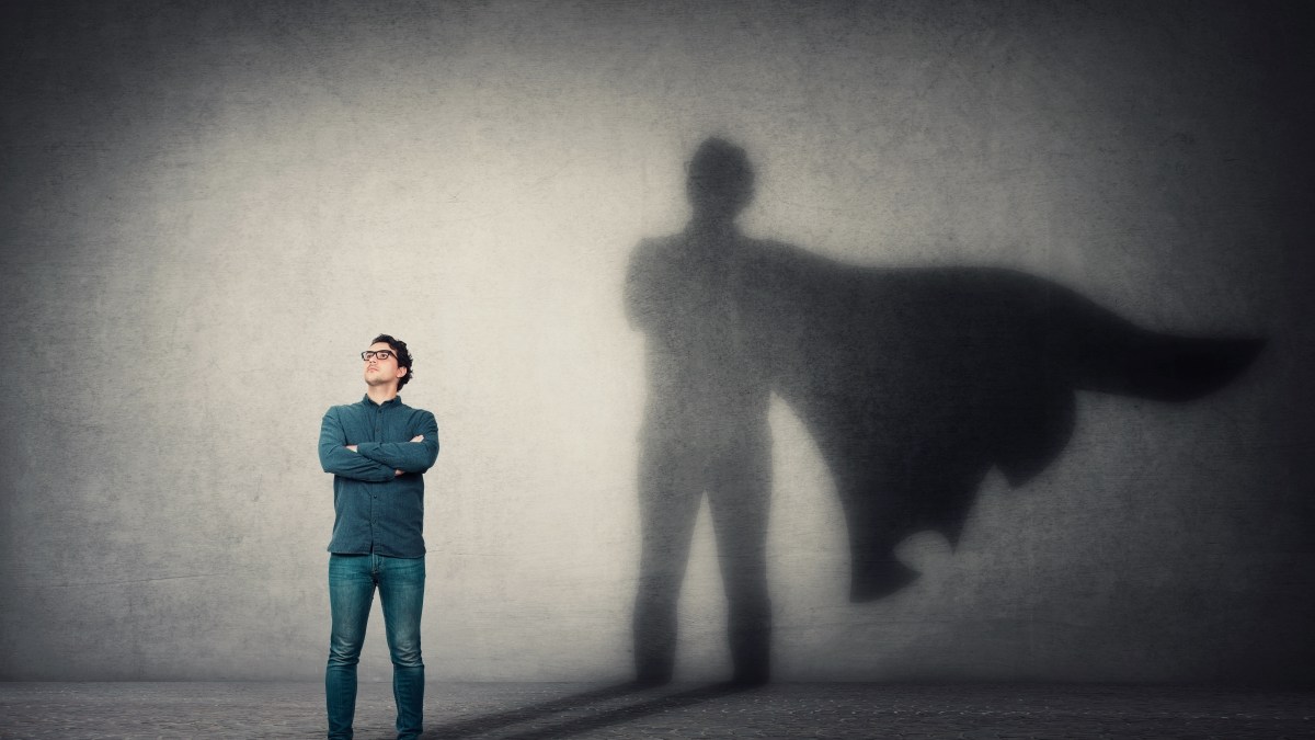 Brave man keeps arms crossed, looks confident, casting a superhero