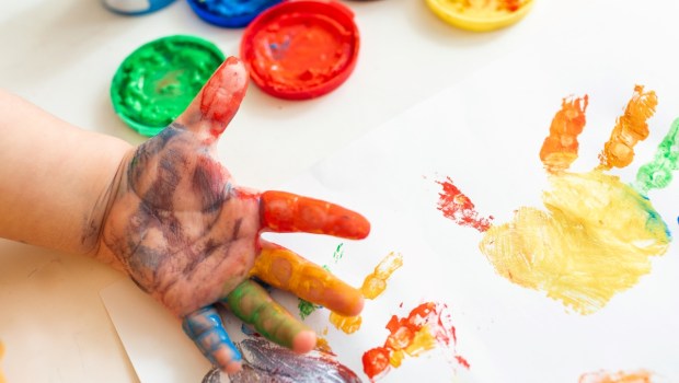 Close up of colored hand print on white background