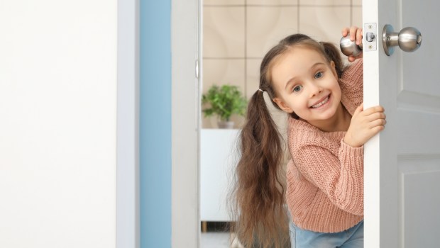 Cute little girl looking out the door