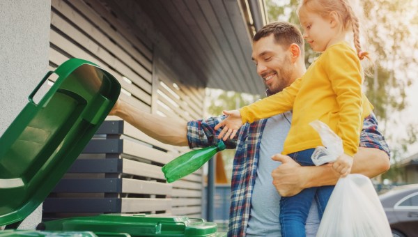 Father and daughter recycling
