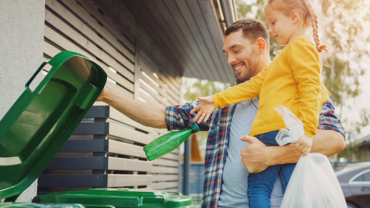 Father and daughter recycling