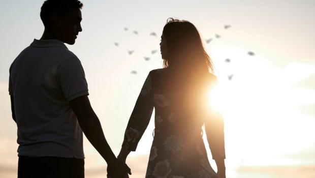 Couple, silhouette and holding hands at romantic, destination