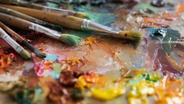 artists brushes and oil paints on wooden palette