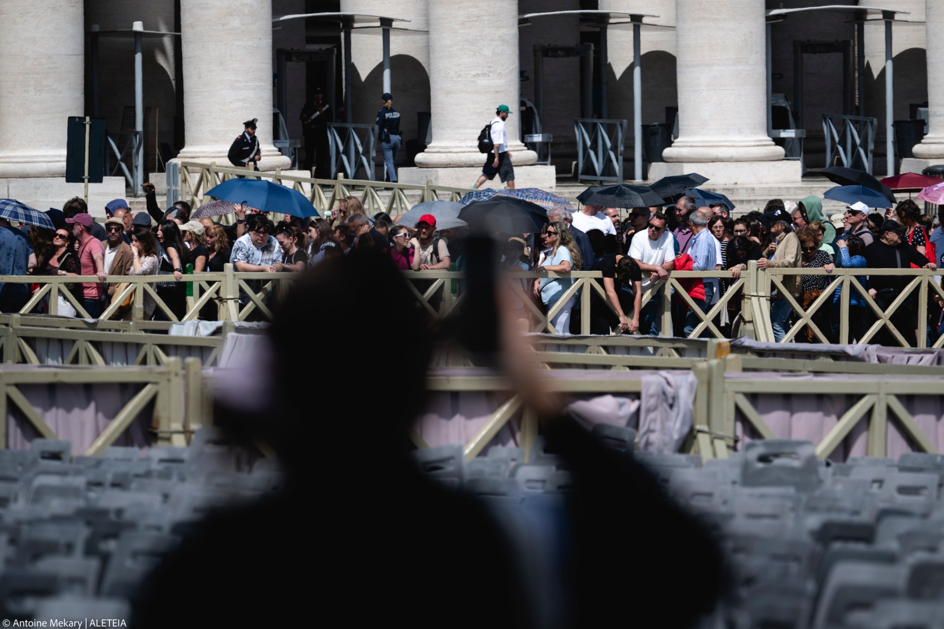 Pilgrims and visitors queue at St Peter's Square to enter St Peter's Basilica and pay respects to the late Pope in the Vatican on April 23, 2025
