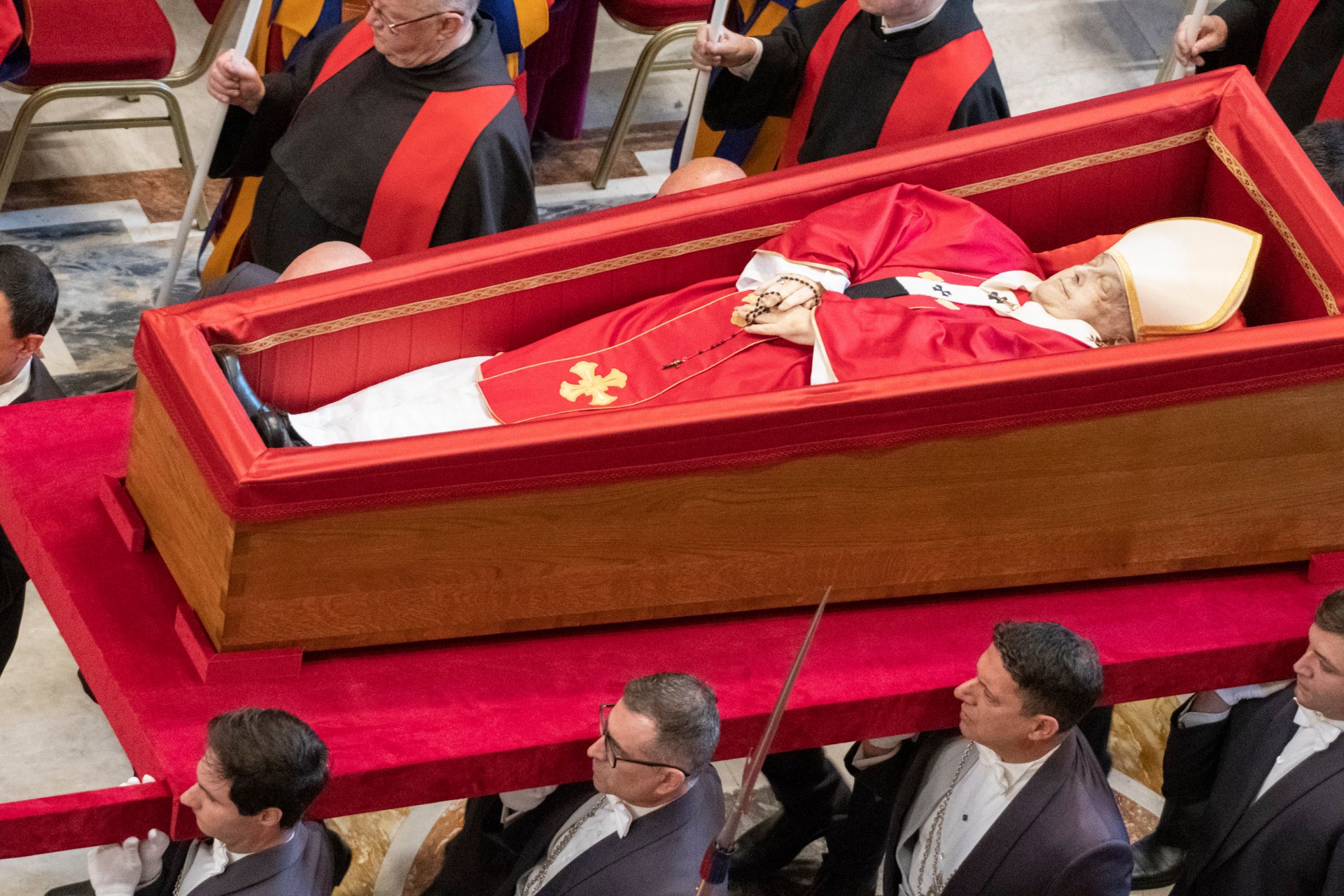 Pallbearers carry the coffin of the late Pope Francis inside St Peter's Basilica as it is transported in a procession from the chapel of Santa Marta to St Peter's Basilica, following the Pope's death, in the Vatican on April 23, 2025.