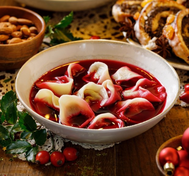 raditional Christmas beetroot soup borsch with dumplings stuffed with mushrooms close up view