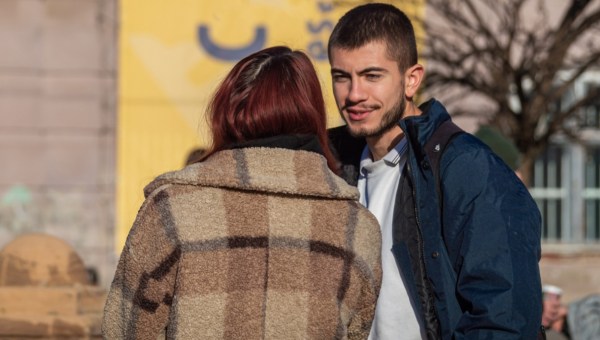 man and woman talking on the street