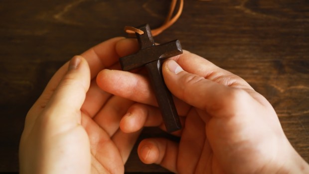 teen holding cross