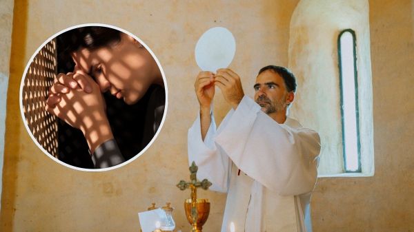 Repentant woman during confession near wooden partition in booth