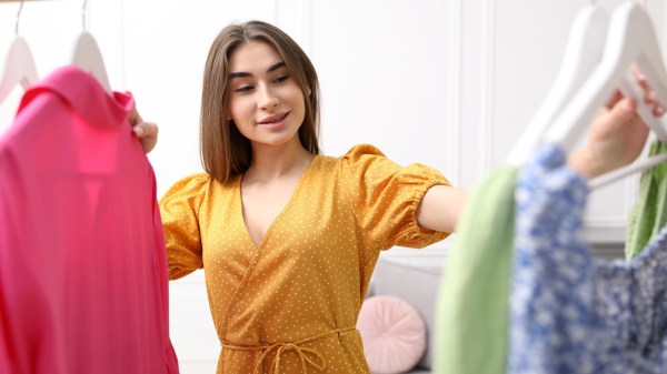Attractive woman choosing dress